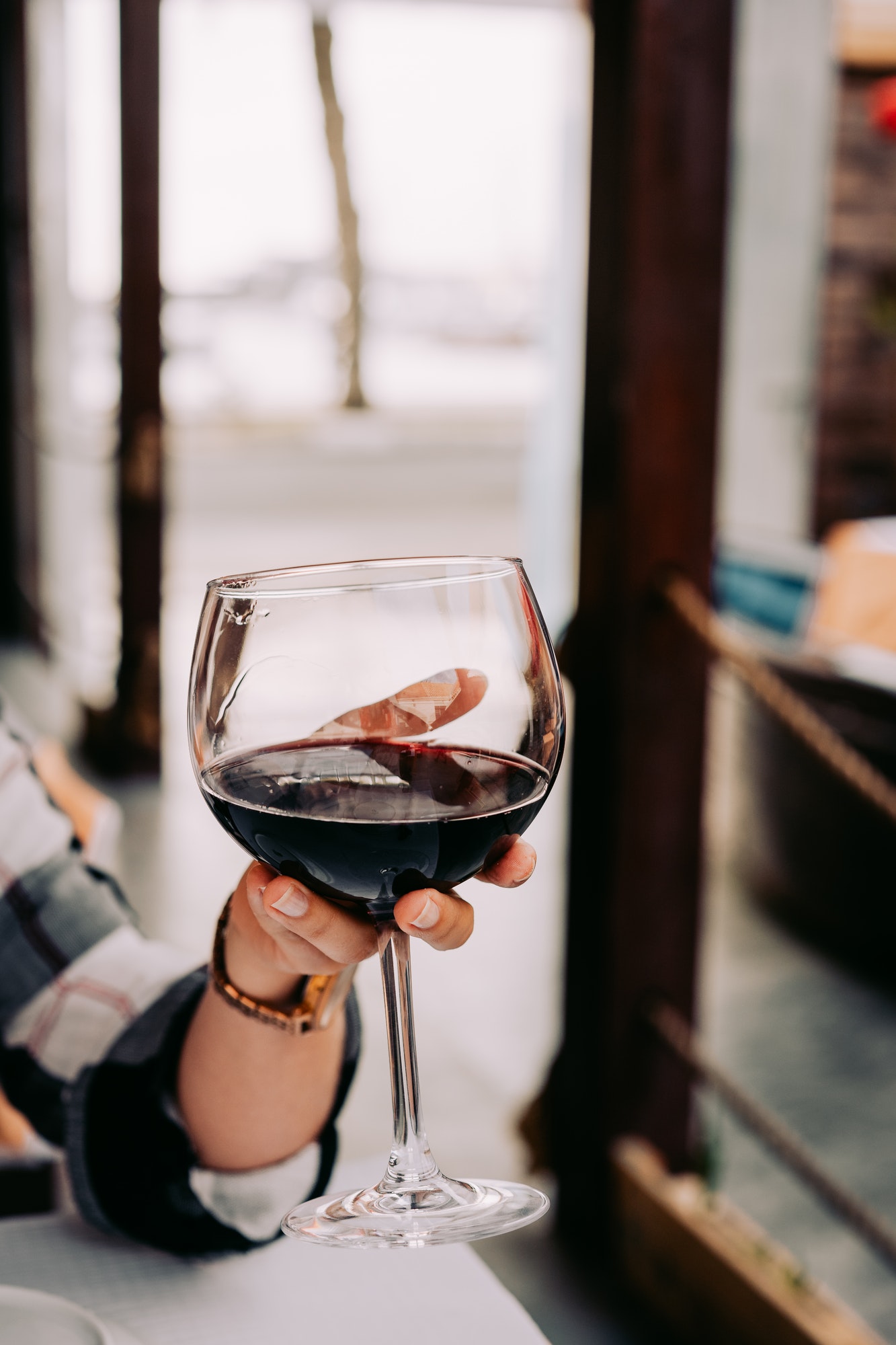 Woman hand holding a wine glass with red wine